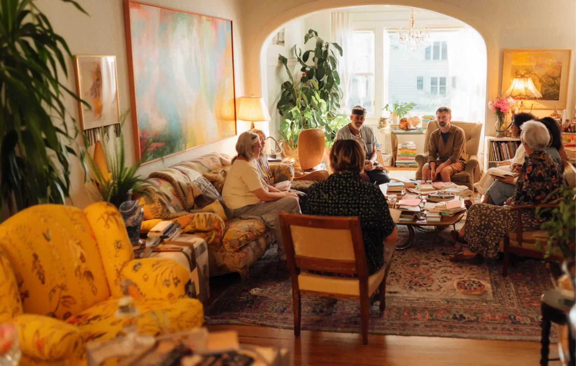 Friends and family gather for conversation in a colorful boho living room