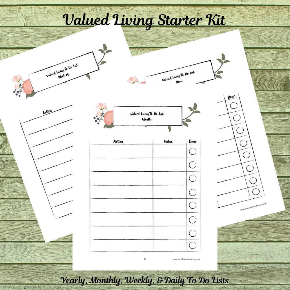 Printed worksheets with fillable sections for yearly, monthly, weekly, and daily to-do lists displayed on green wood surface
