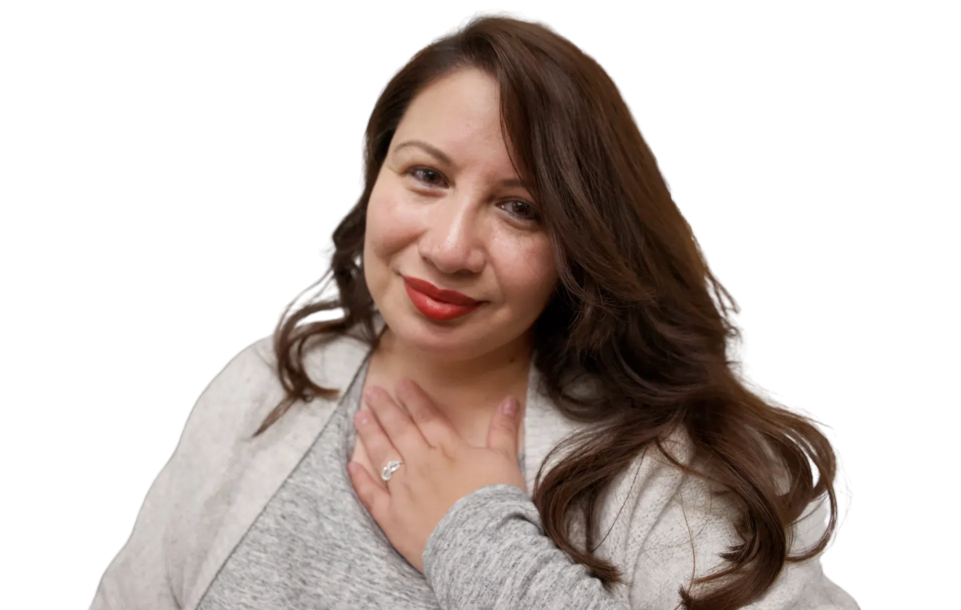 Sofia Mendoza smiles gently with her hand resting on her chest